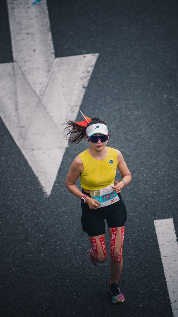 Woman running on an asphalt road during a morning race, sports and fitness